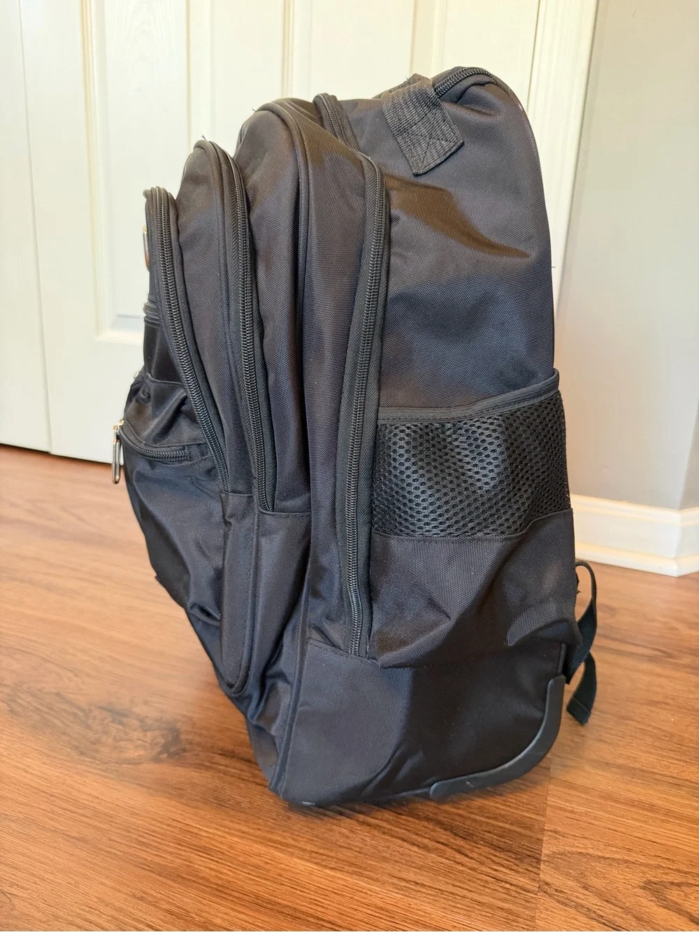 Black Everyday Rolling Travel Backpack with Multiple Pockets